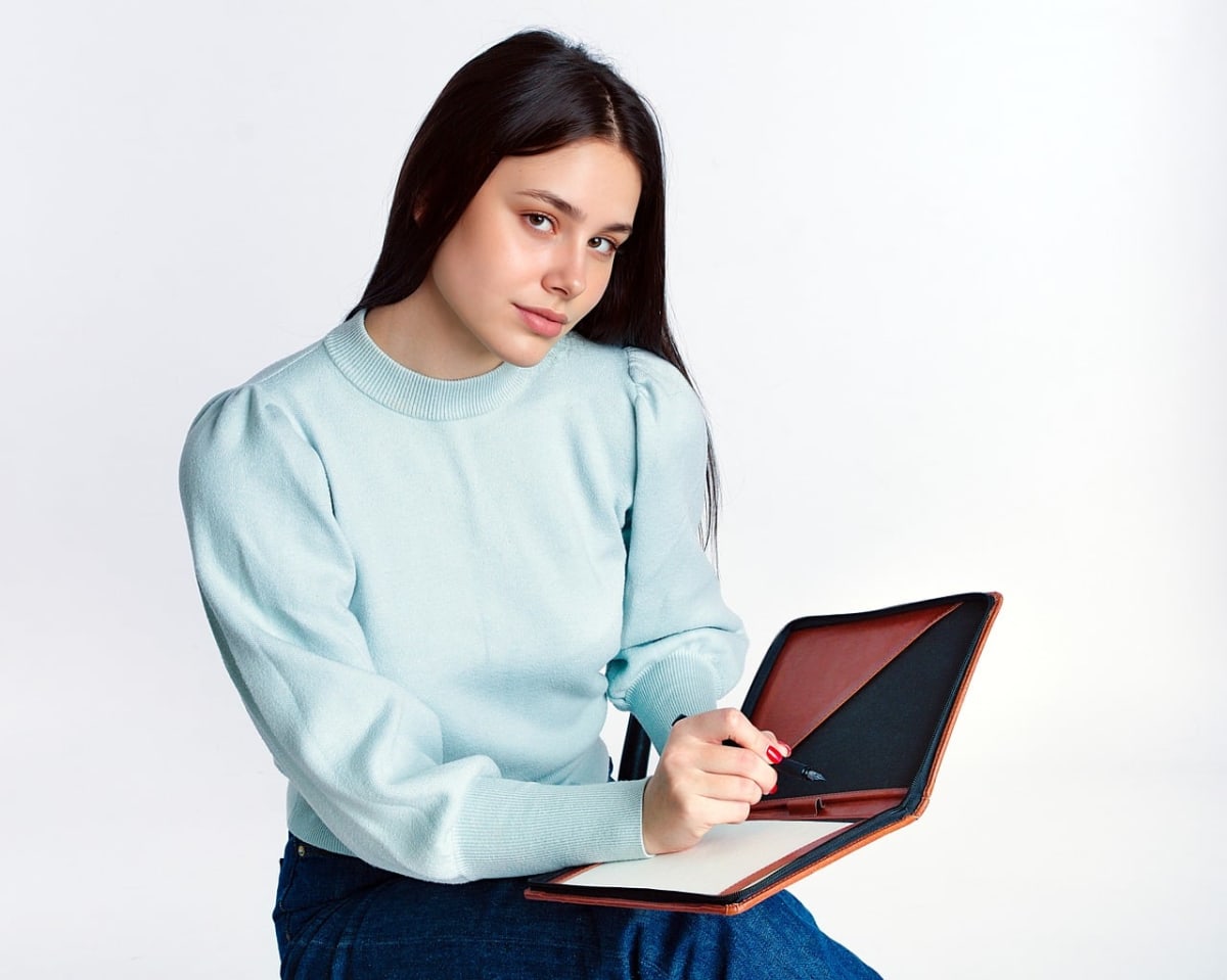 Young professional writing laptop office