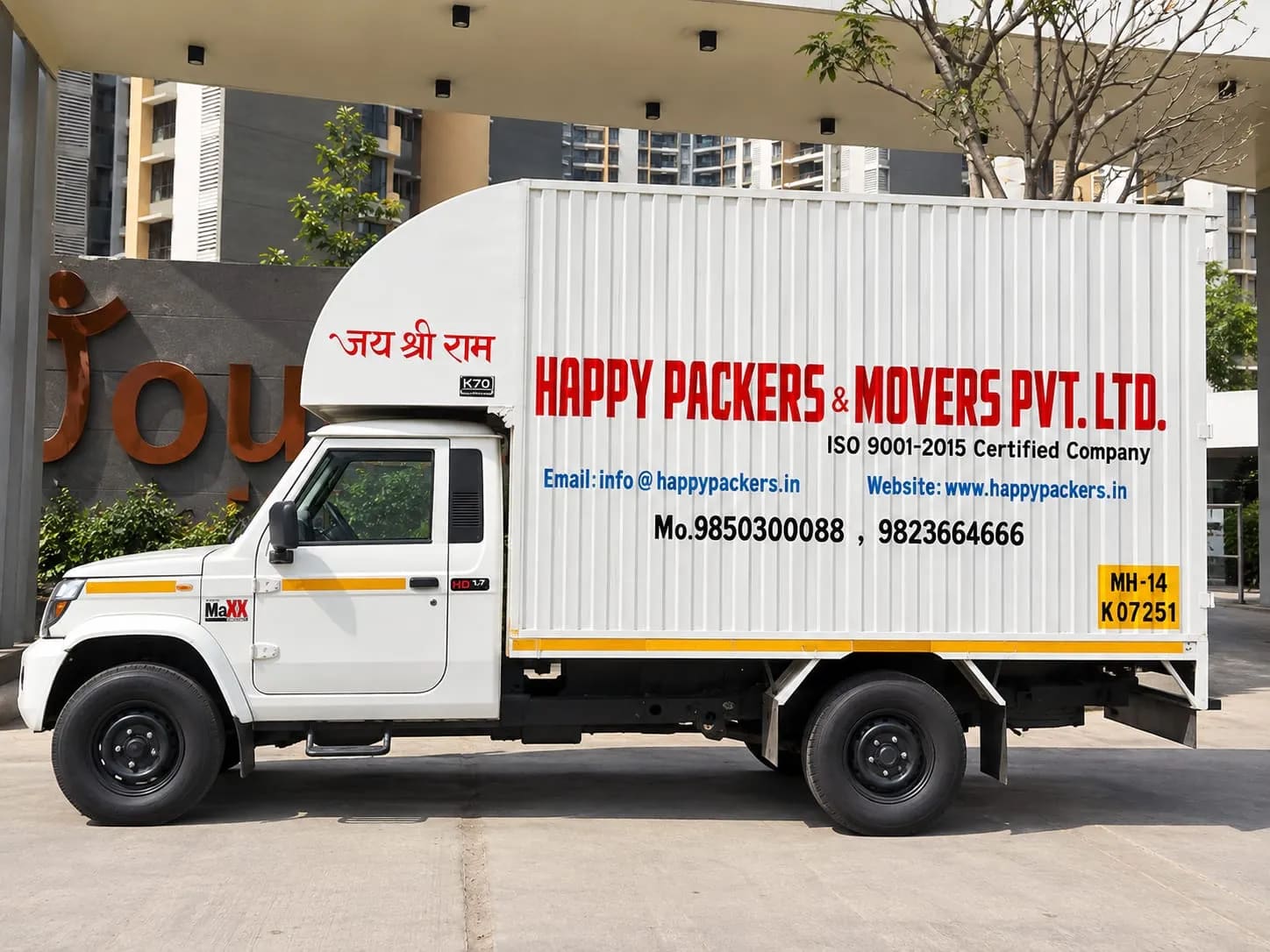 Happy Packers and Movers goods carrier truck showing the company name and ISO 9001:2015 certification