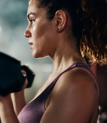 A resident works out in fitness center University Lofts in Jonesboro, Arkansas