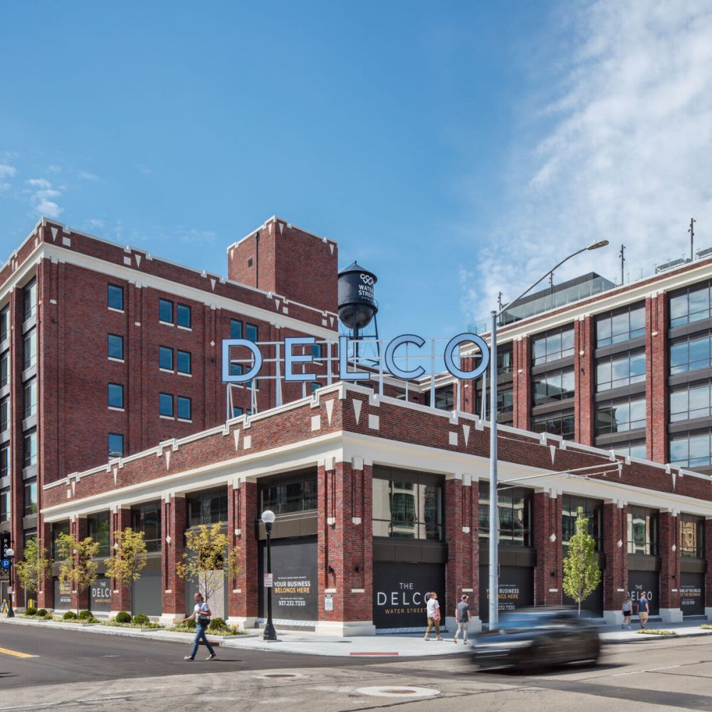 Beautiful exterior view of the apartment building showing the entrance at The Delco in Dayton, Ohio