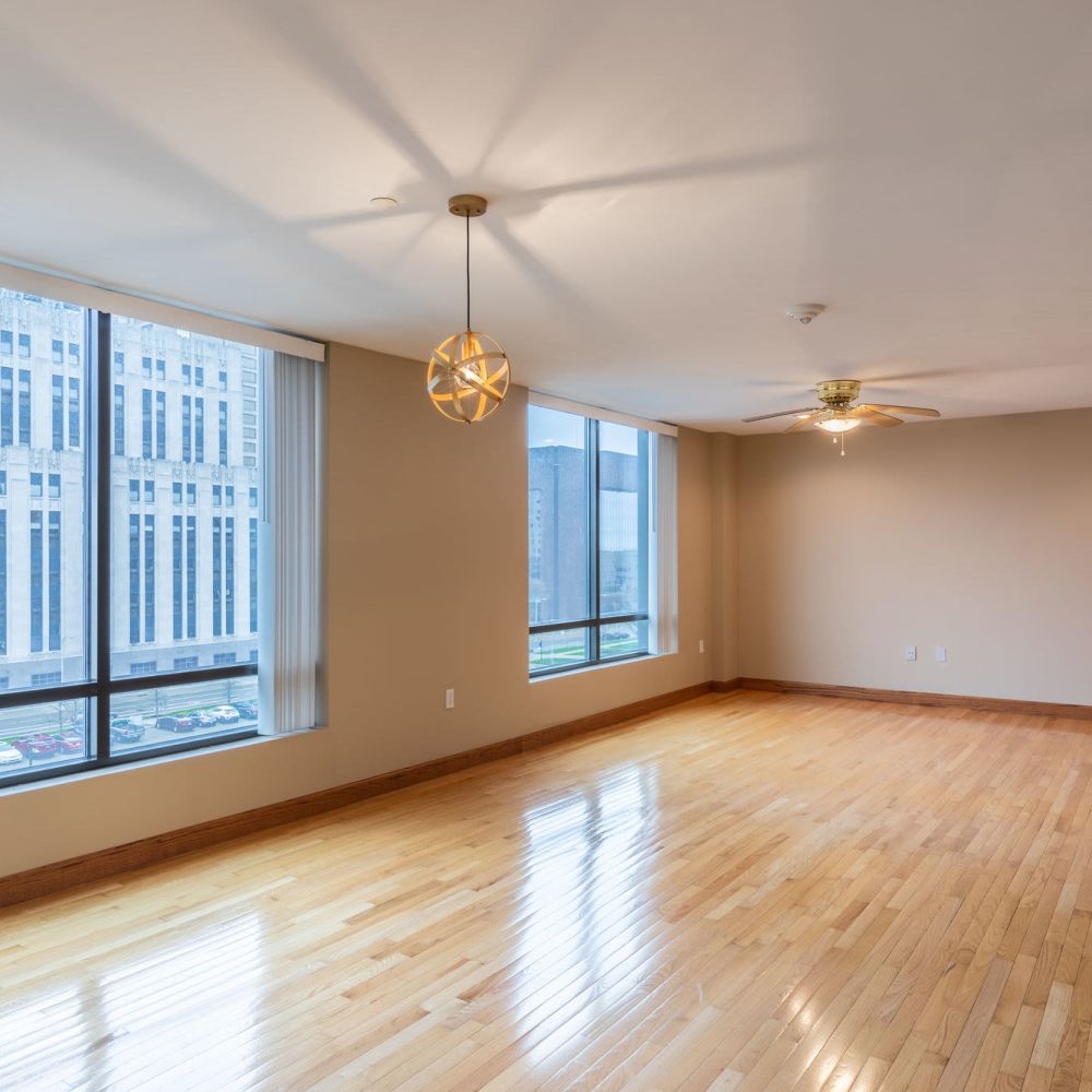 Empty living area with large windows at Stratford House in Dayton, Ohio