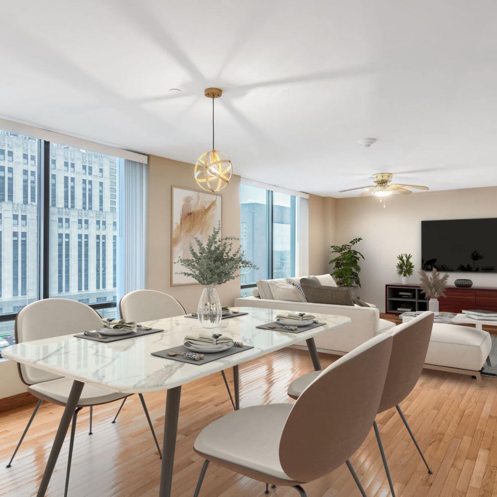 Bright living and dining space with large windows at Stratford House in Dayton, Ohio