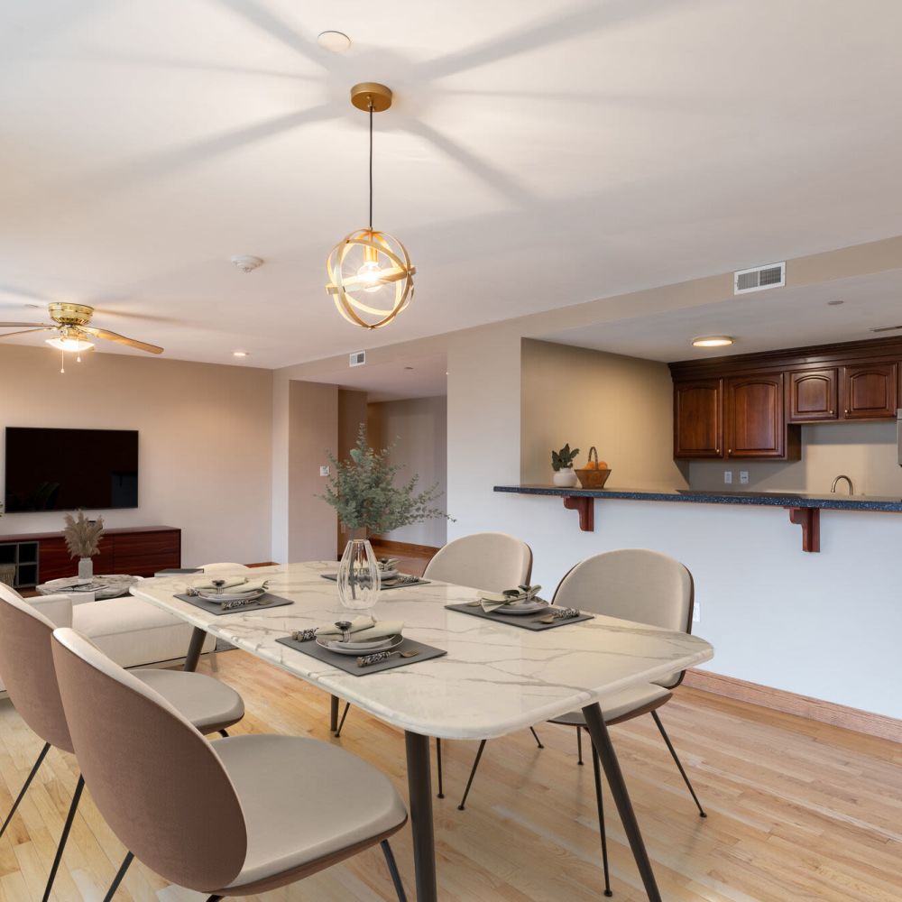 Open dining and living area with modern kitchen at Stratford House in Dayton, Ohio