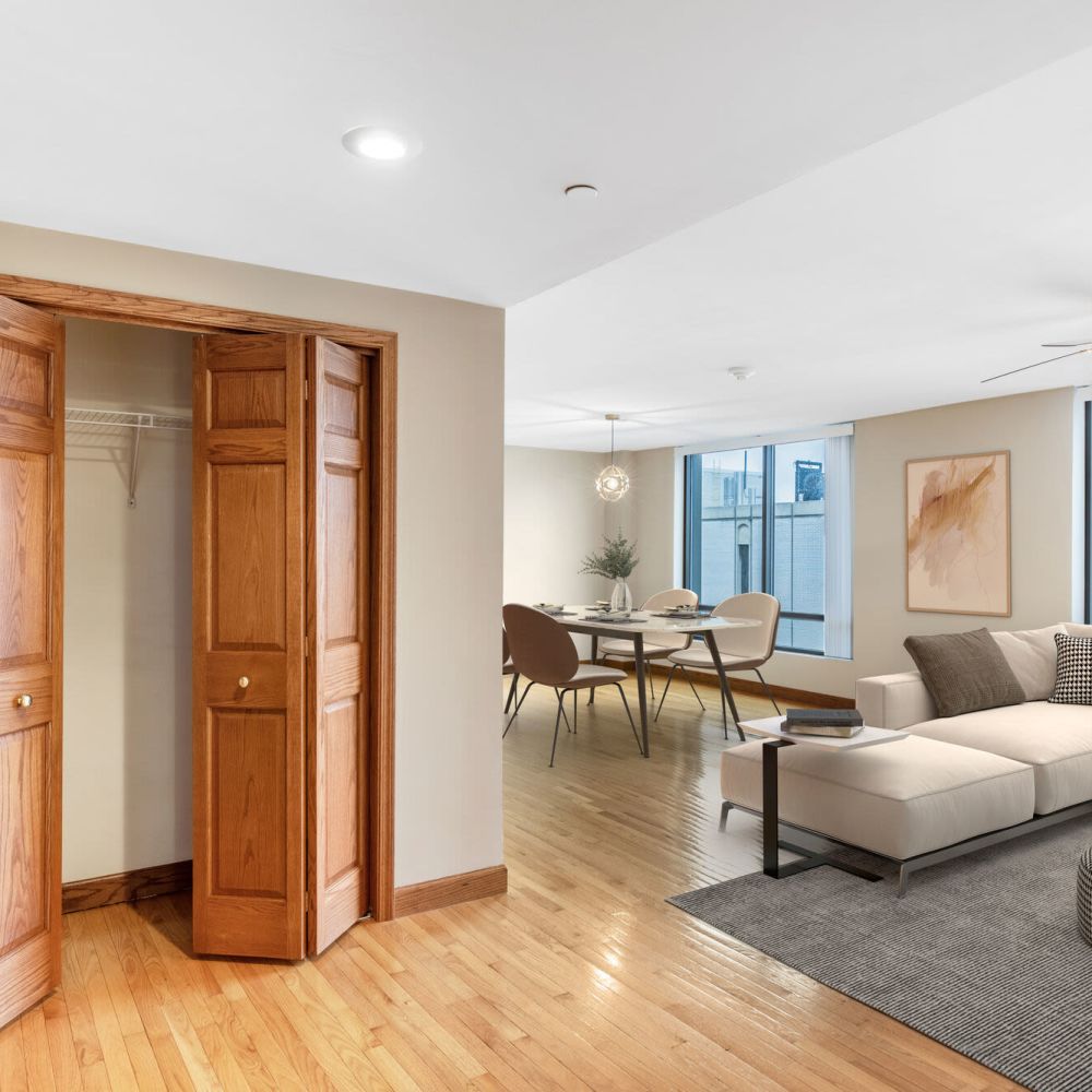 Living room with open closet and connected dining area at Stratford House in Dayton, Ohio