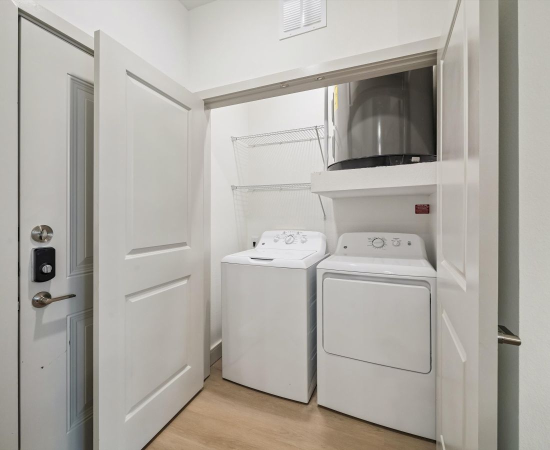 Modern washer and dryer in a closet at Dakota at Hillcroft in Houston, Texas