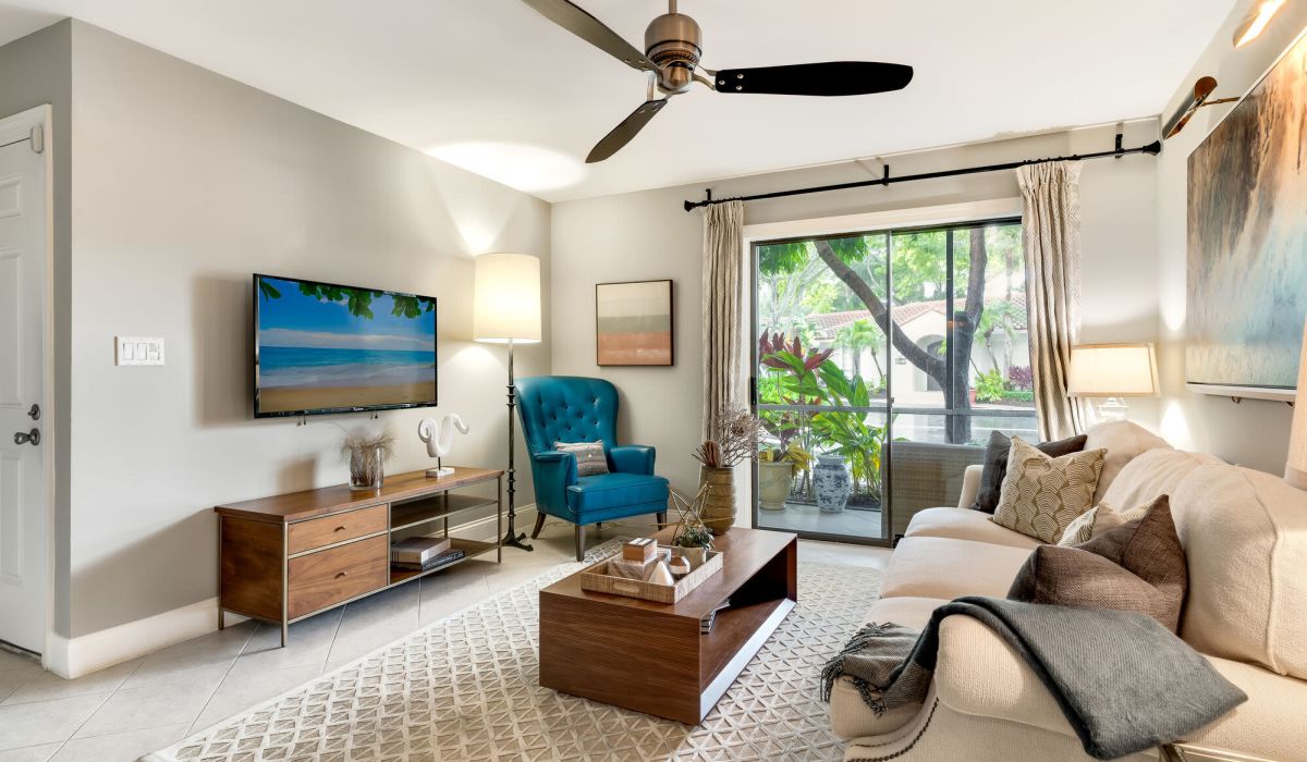 Living room with a way to patio at Mizner Court in Boca Raton, Florida
