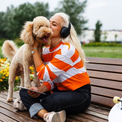 Woman cuddling dog on park bench near Treehaven in Summerville, South Carolina