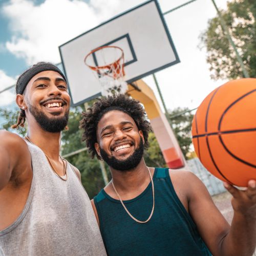 Modern basketball held by smiling individuals at Ivy Park in Baton Rouge, Louisiana