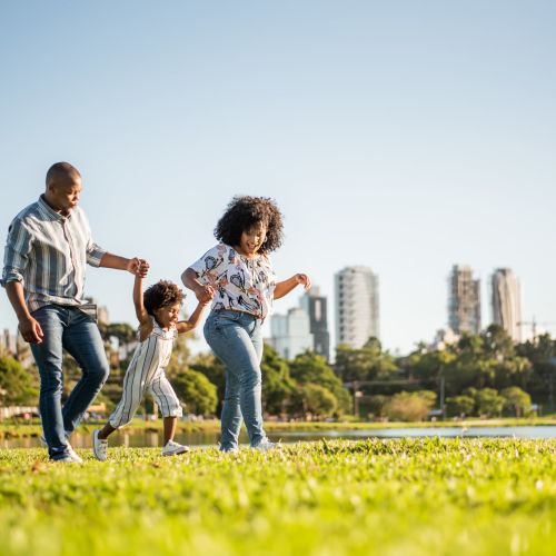 Family playing together in a nearby park at North Road Townhomes in Scottsville, New York