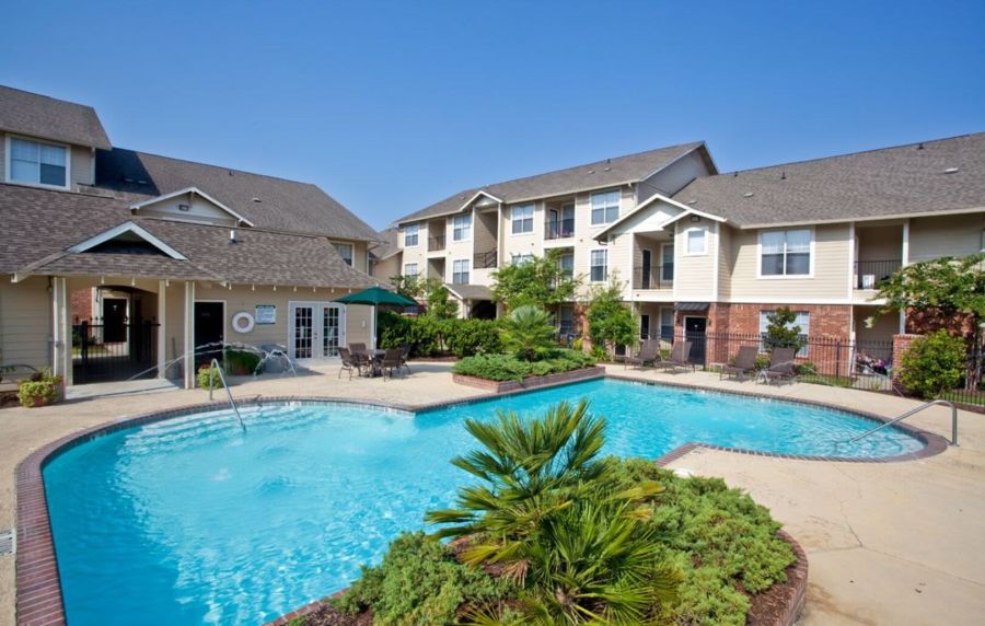 Gated swimming pool with landscaping and seating at Ivy Park in Baton Rouge, Louisiana