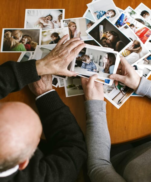 Couple looking at photographs together at Grand Villa Senior Living in Clearwater, Florida