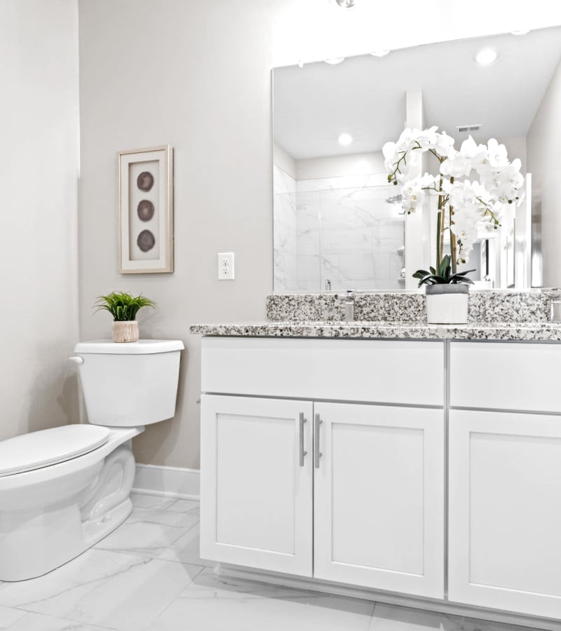 Bathroom with granite countertops at Village Square Apartments in Norfolk, Virginia