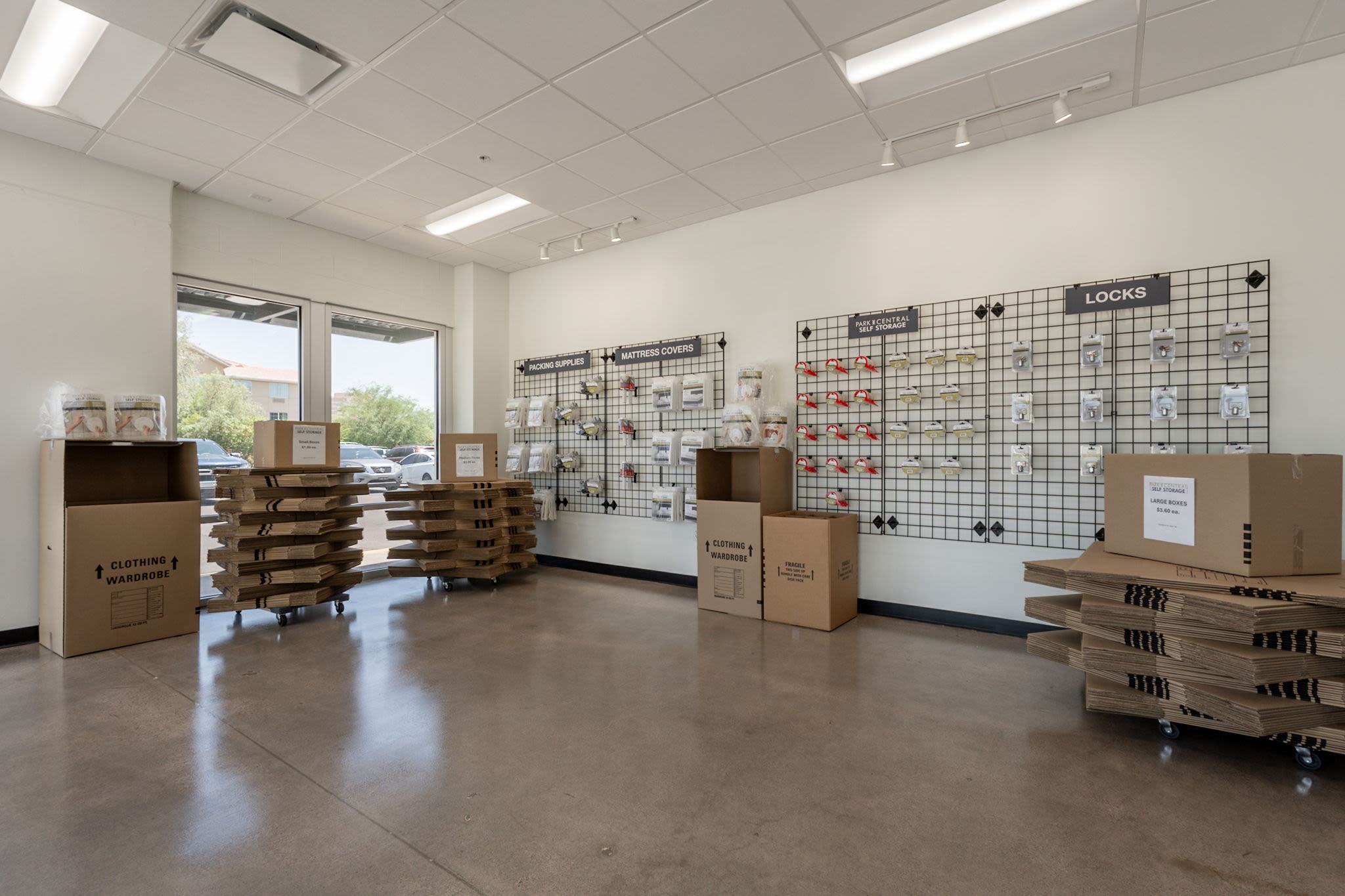 Storage supply area with boxes, packing materials, and items displayed on wall panels at Park Central Self Storage in Phoenix, Arizona