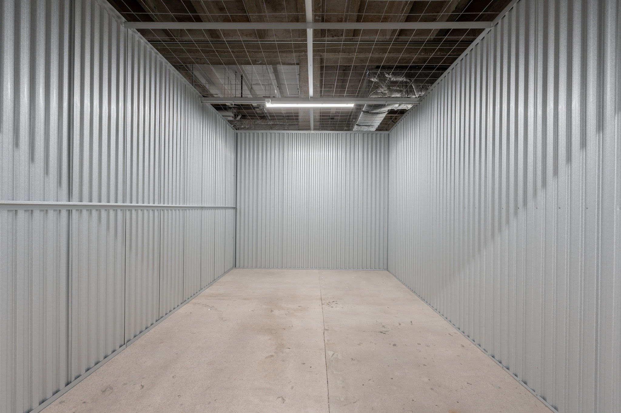 Empty storage unit with metal walls and a concrete floor at Park Central Self Storage in Phoenix, Arizona