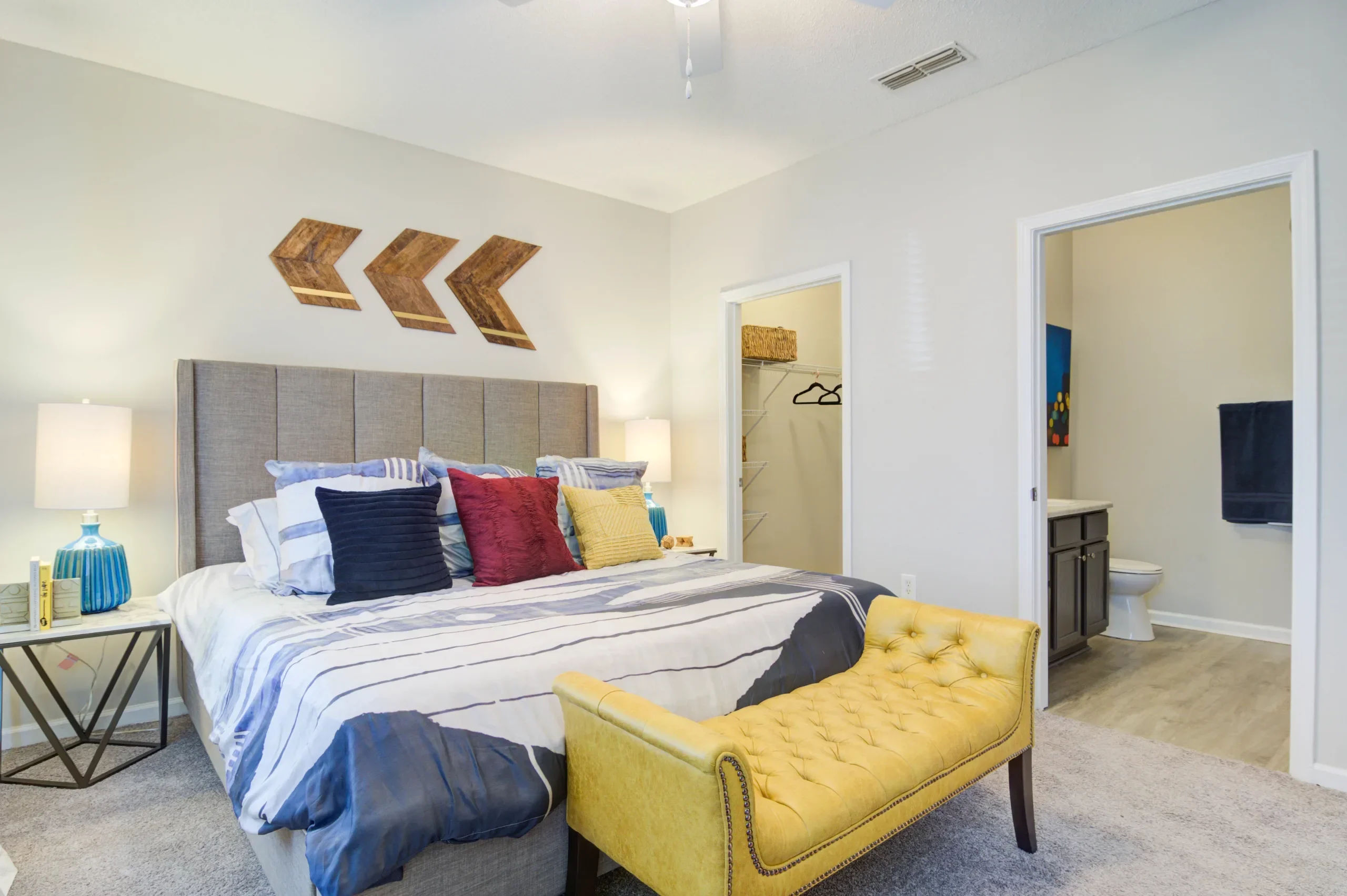 A cozy bedroom with a walk-in closet at Villas at Princeton Lakes in Atlanta, Georgia