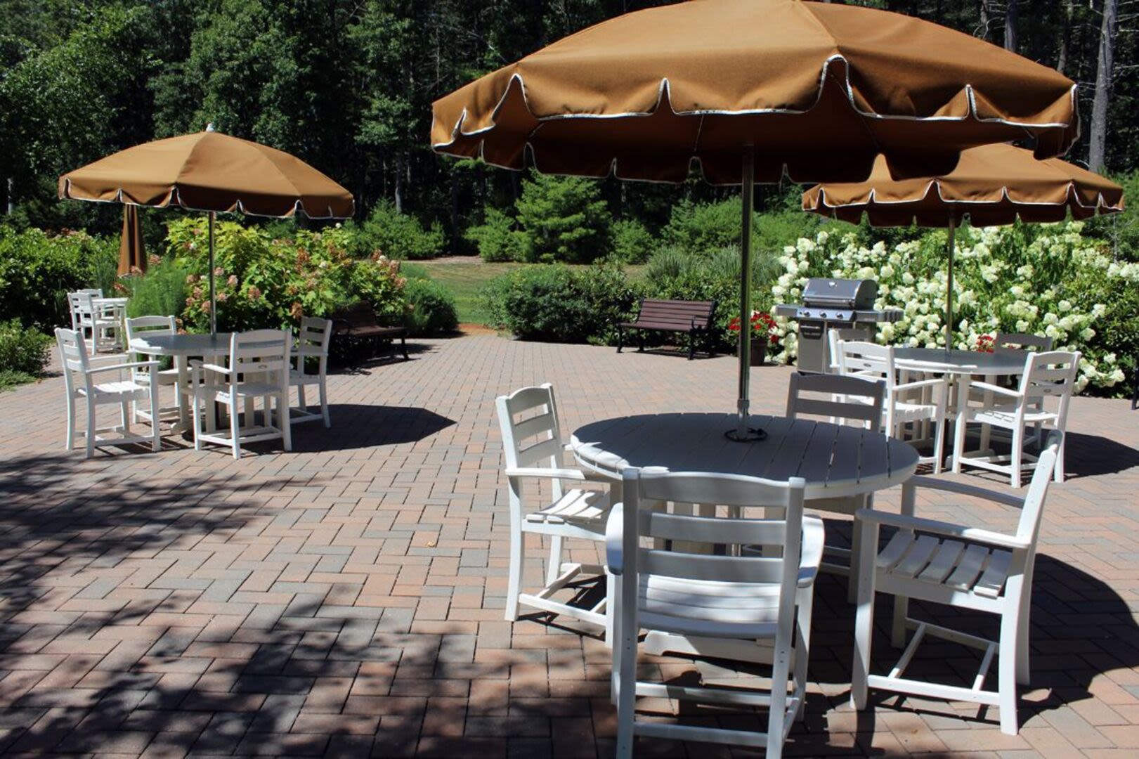 Outdoor patio with BBQ area at Barstow Village in Hanover, Massachusetts