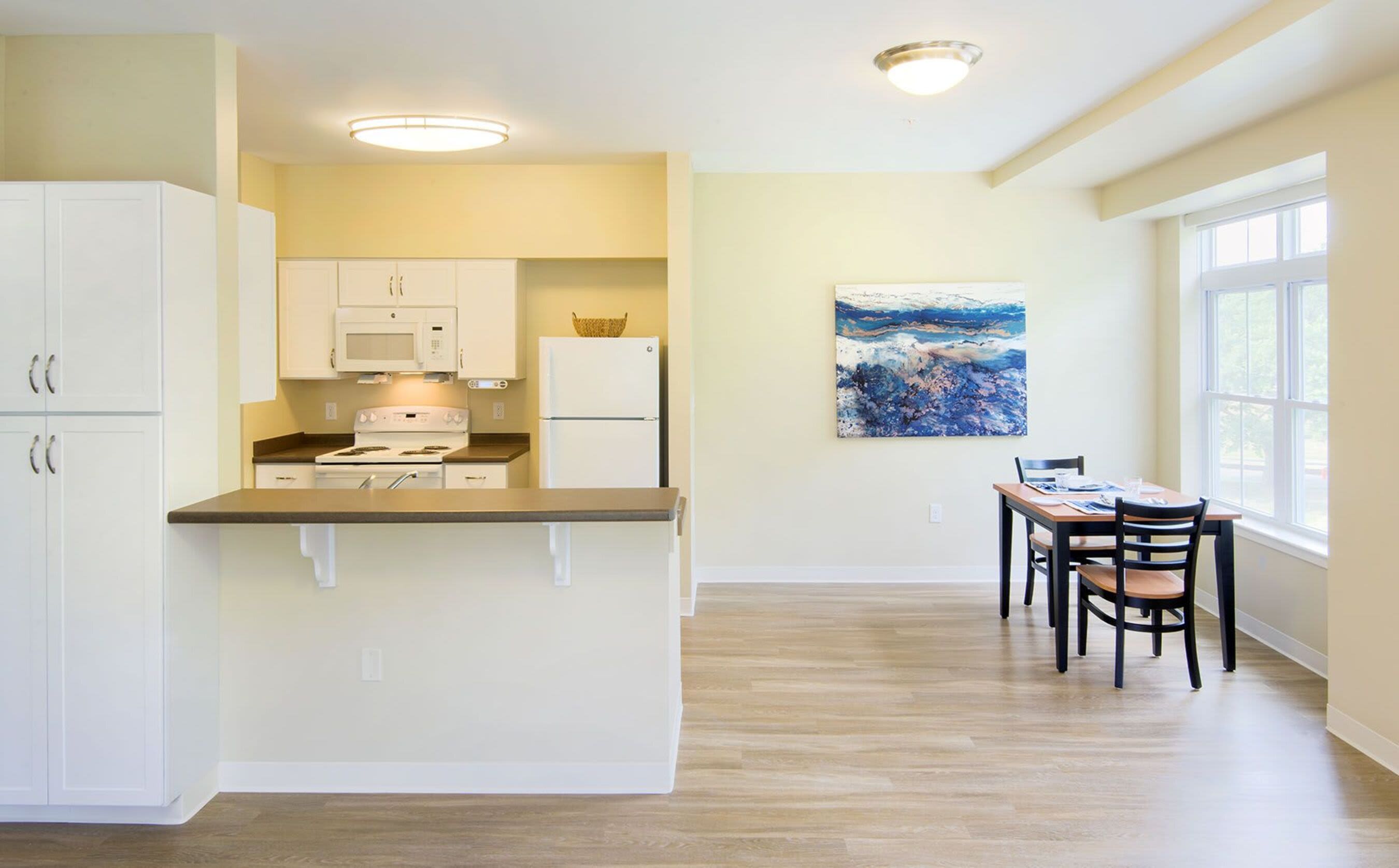 View of kitchen and dining area at Bedford Green Apartments in Bedford, Massachusetts