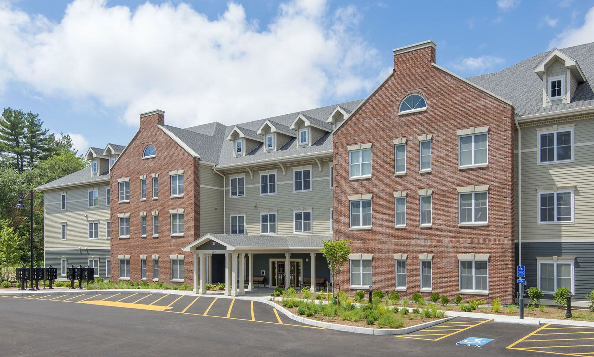 Exterior view of the community apartment with parking space at Bedford Green Apartments in Bedford, Massachusetts