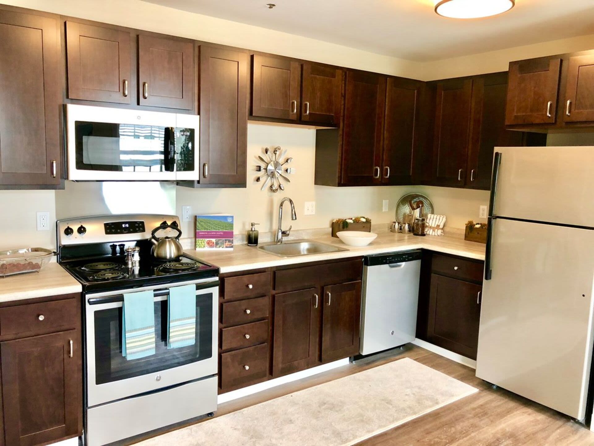 Kitchen with appliances and wooden cabinets at Bethany Apartments in Hanover, Massachusetts