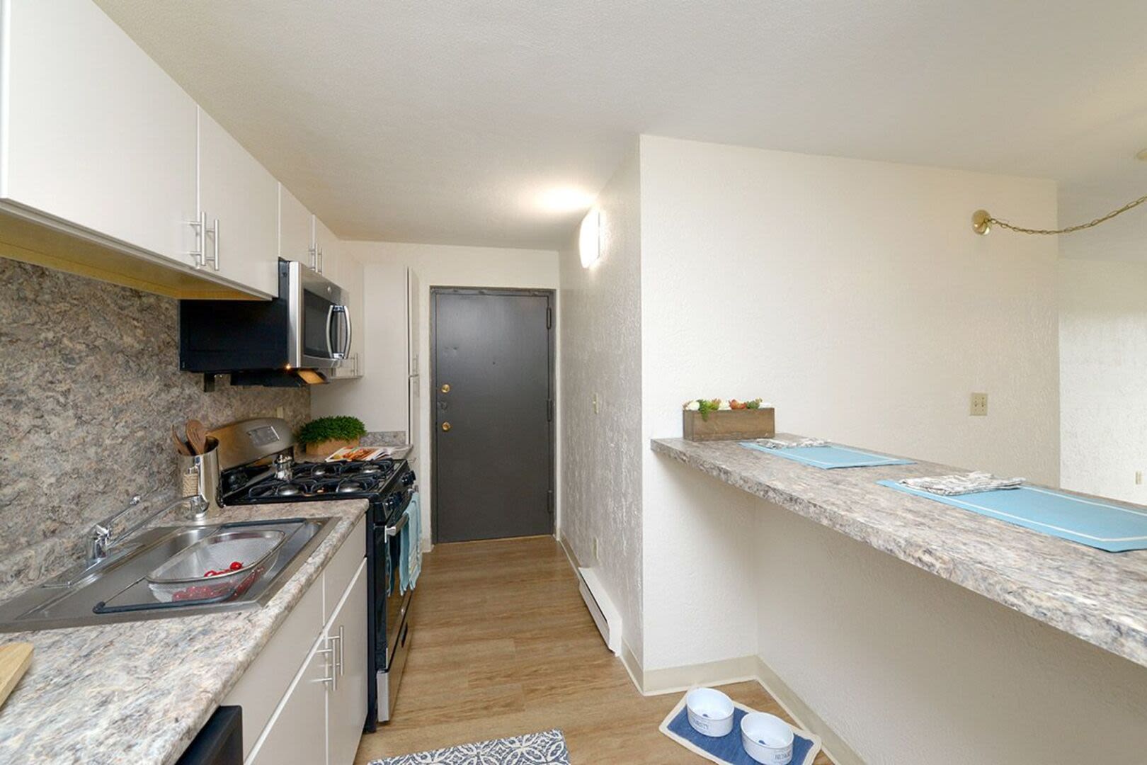 An apartment kitchen with granite countertops at Braintree Village in Braintree, Massachusetts