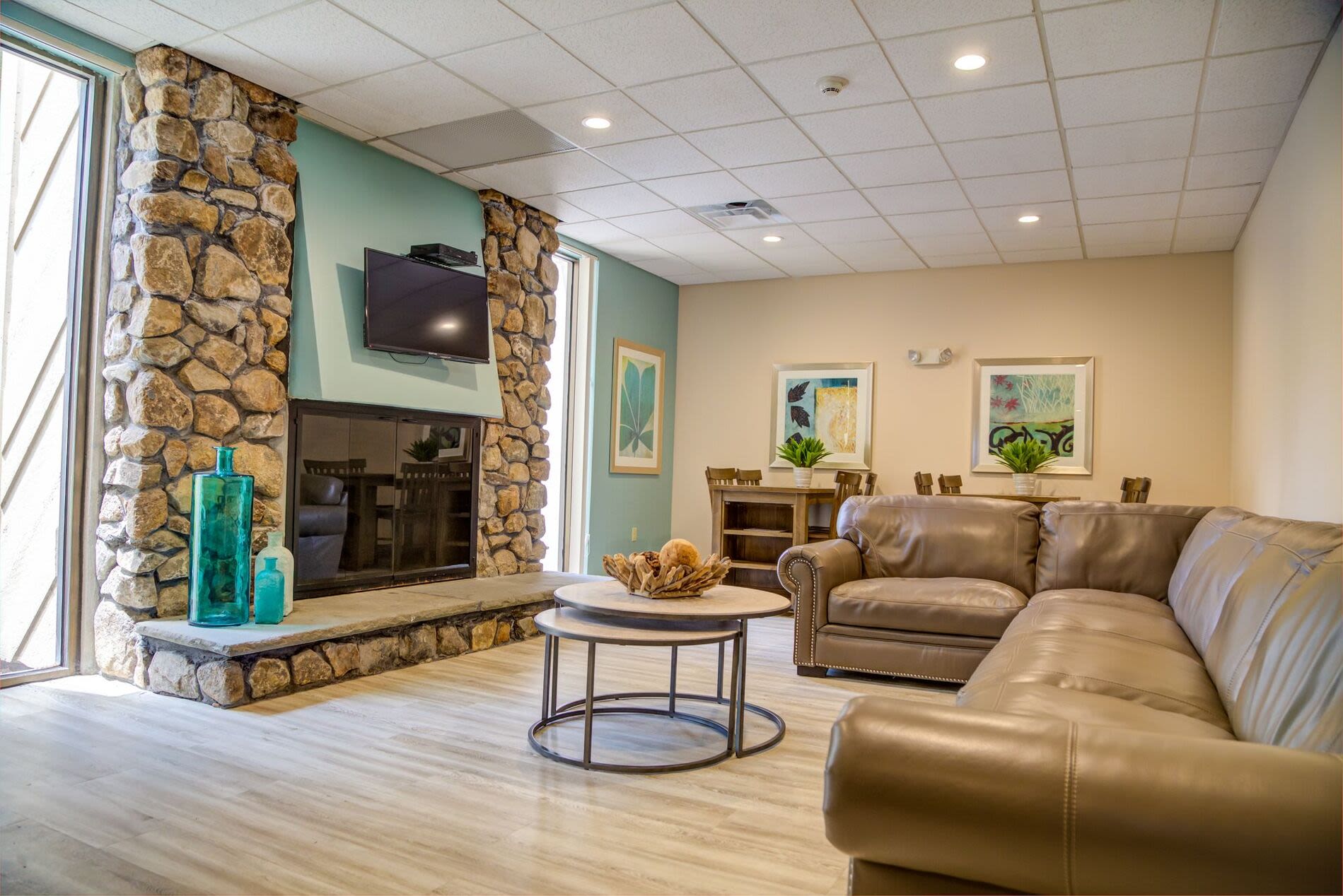 Modern design clubhouse with large lounge chairs and flat screen televisions at Braintree Village in Braintree, Massachusetts