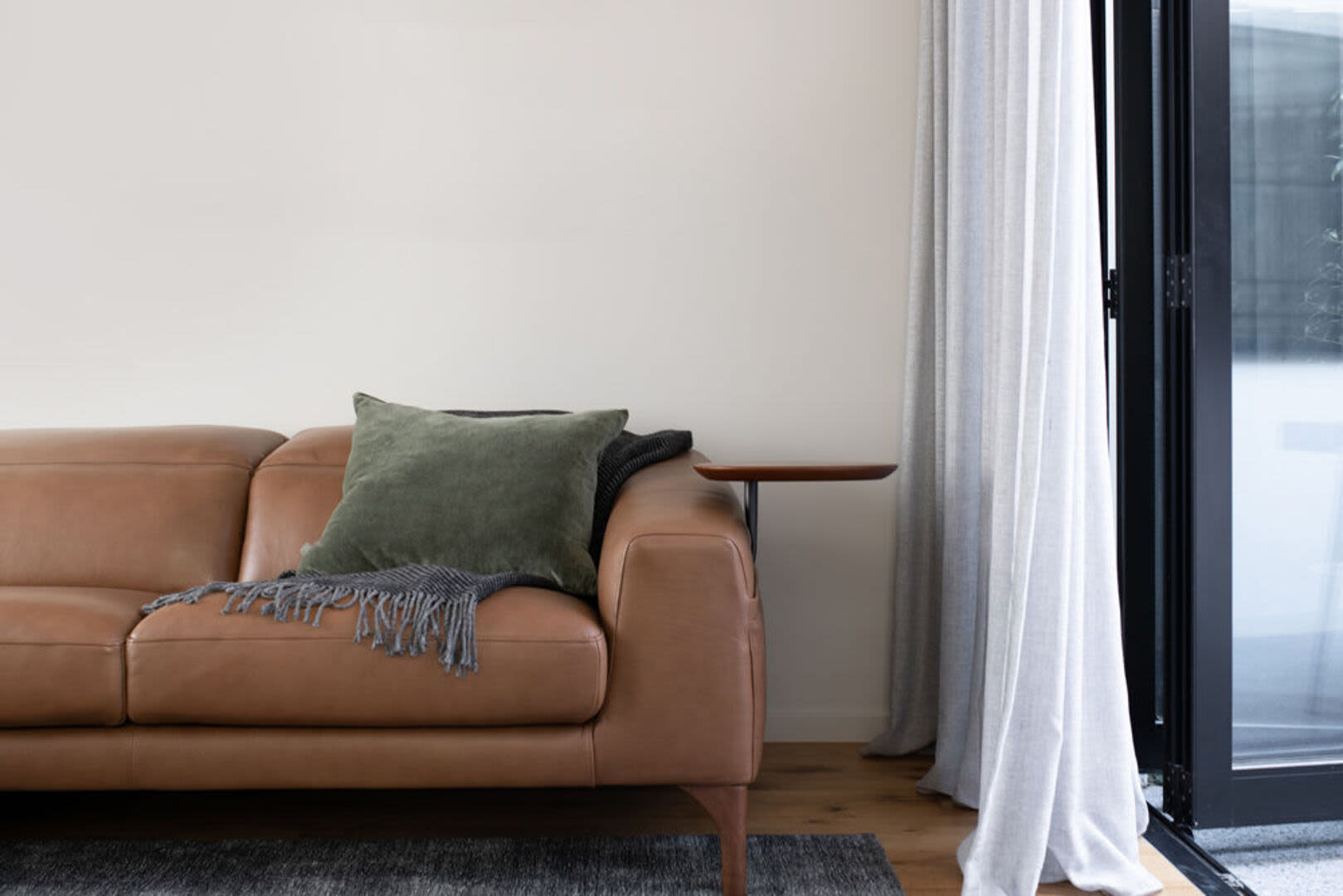 Spacious living room with couch at Brook Avenue Apartments in Roxbury, Massachusetts