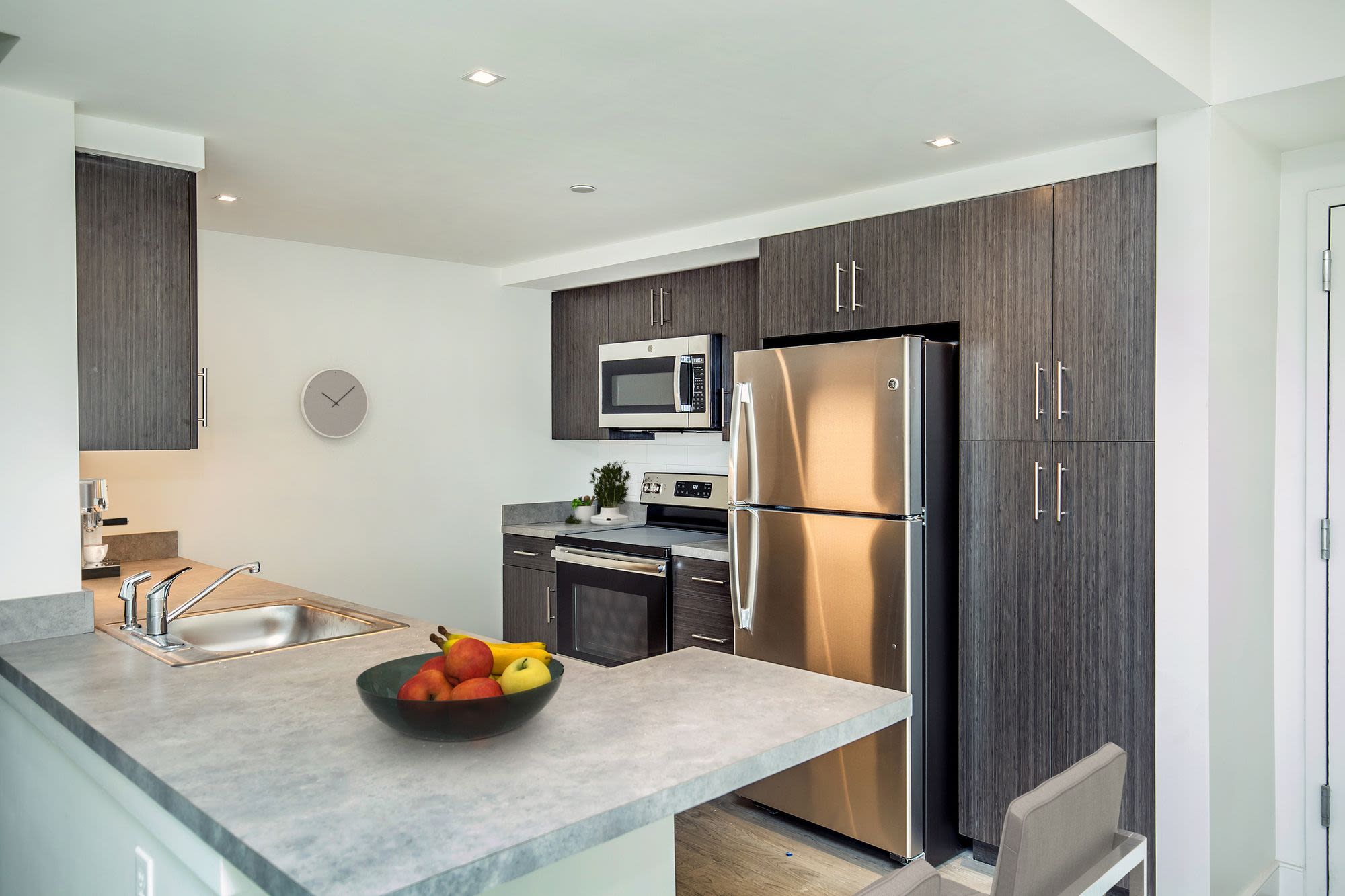 Kitchen with granite countertop and appliances at Coppersmith Village in East Boston, Massachusetts