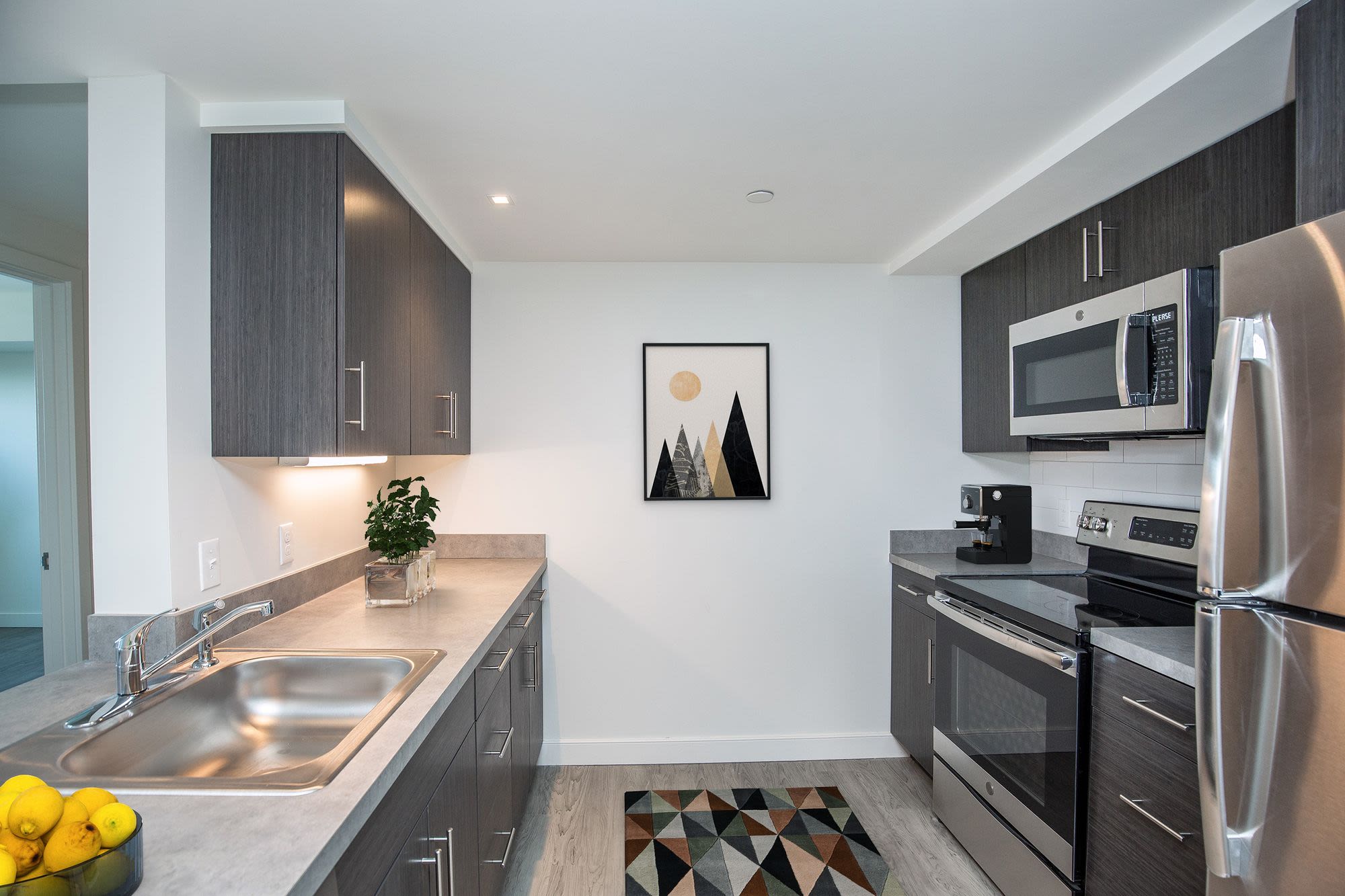Fully-equipped kitchen with appliances at Coppersmith Village in East Boston, Massachusetts
