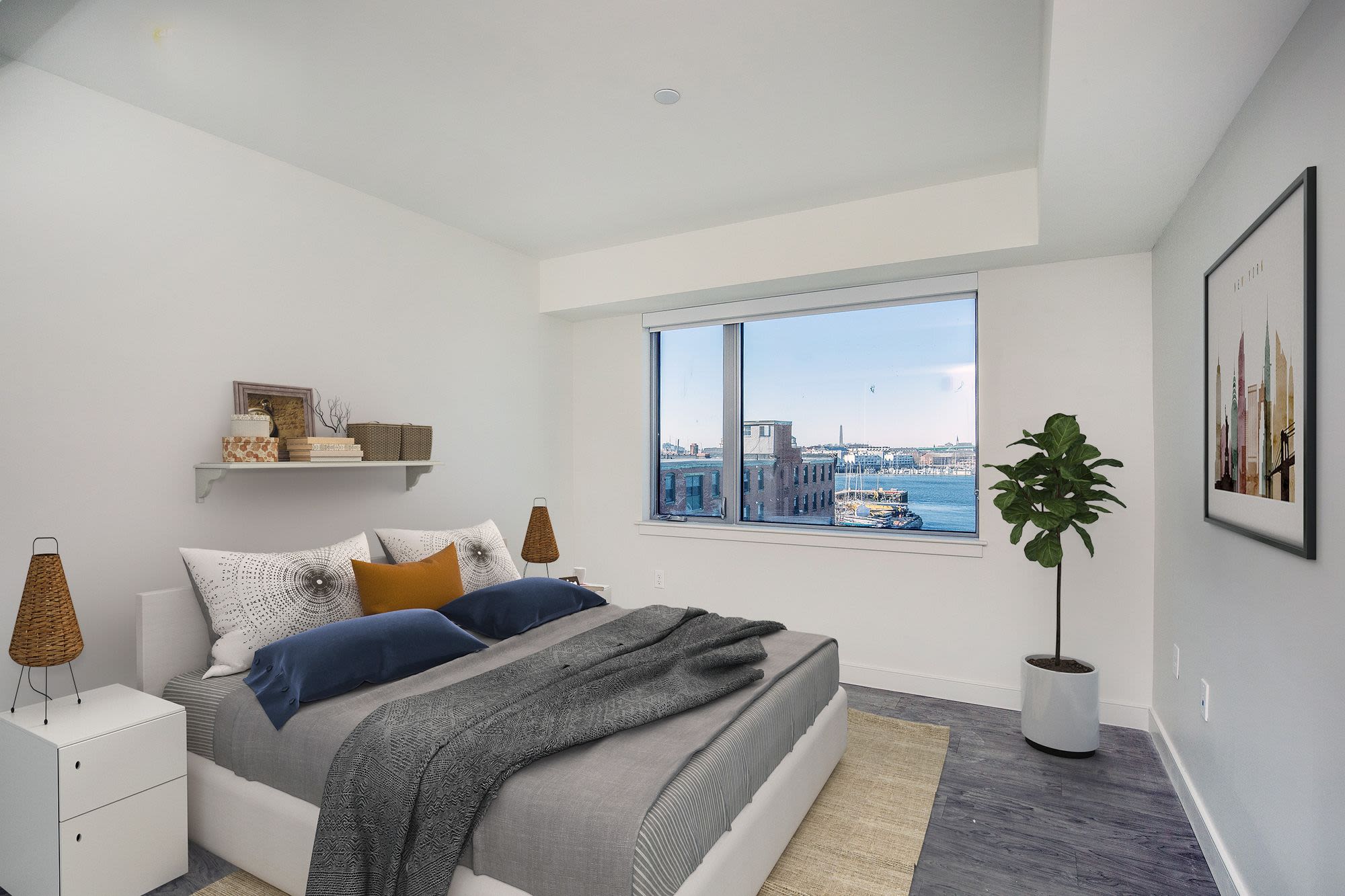 Bedroom with large comfortable bed and a window at Coppersmith Village in East Boston, Massachusetts