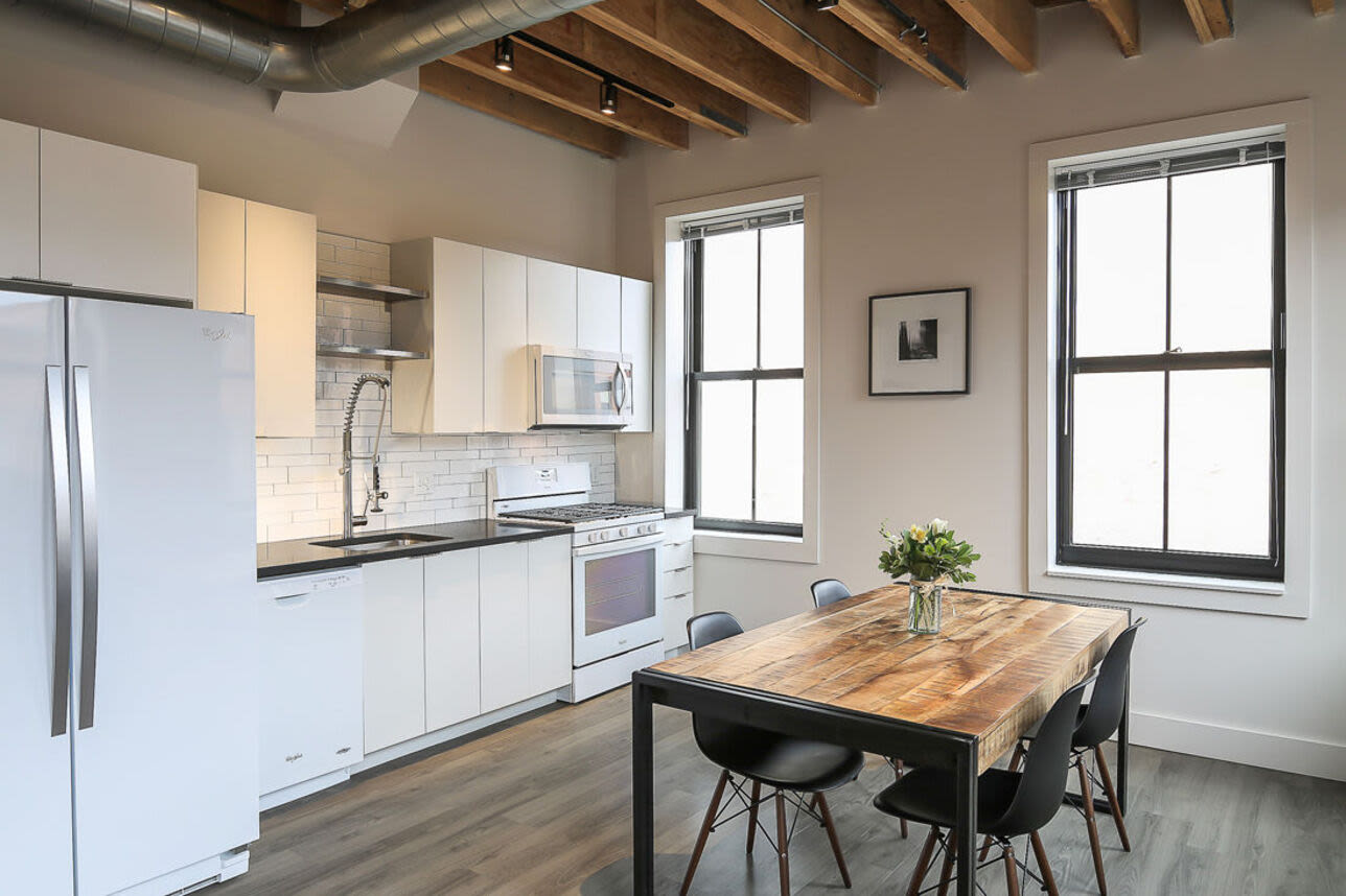 Fully equipped kitchen and dining area at J.M. Lofts in Haverhill, Massachusetts