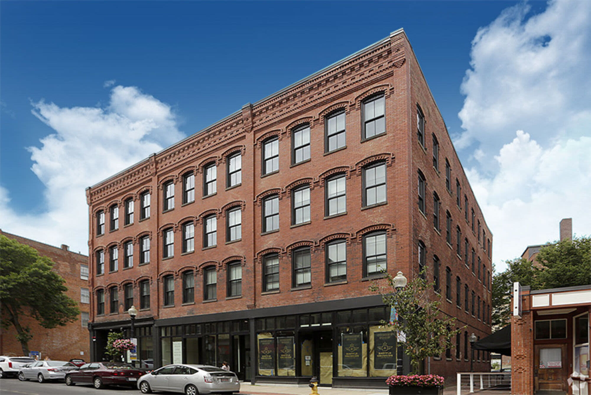 Exterior view of building with car parking at J.M. Lofts in Haverhill, Massachusetts