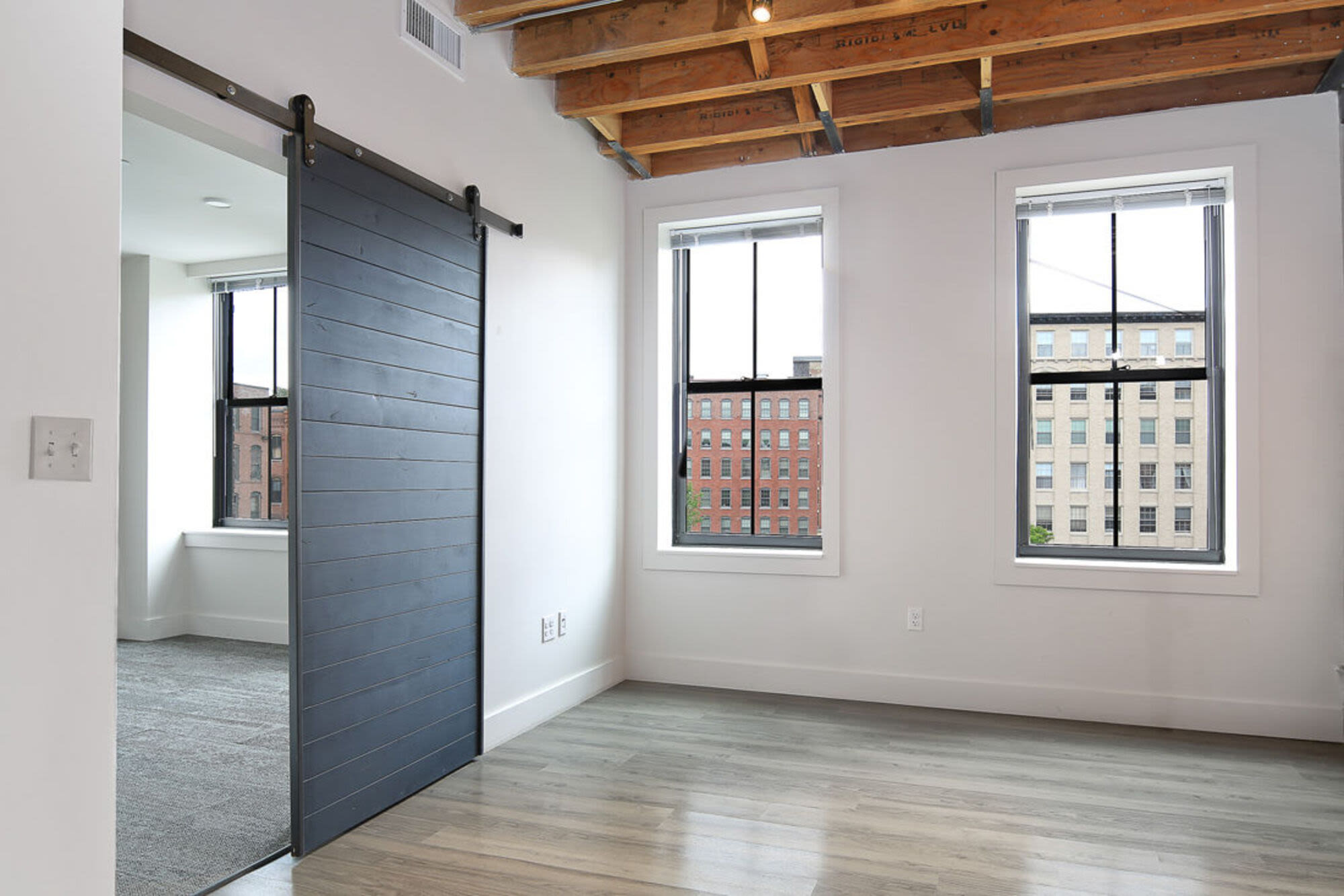 Open layout of living room with access to bedroom at J.M. Lofts in Haverhill, Massachusetts