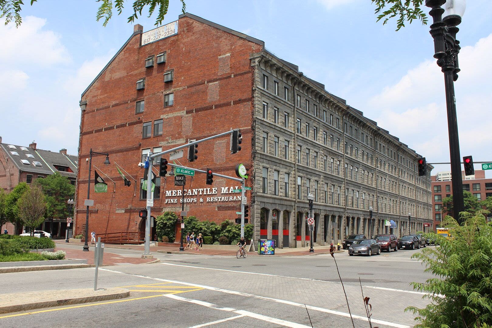 The building exterior showcases parked vehicles lining the nearby road at Mercantile Wharf in Boston, Massachusetts