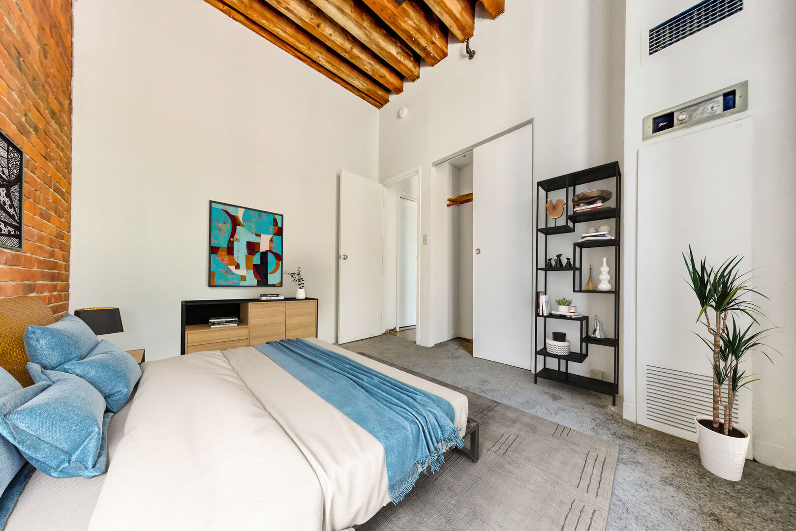 Comfortable bedroom with side lamps at Mercantile Wharf in Boston, Massachusetts