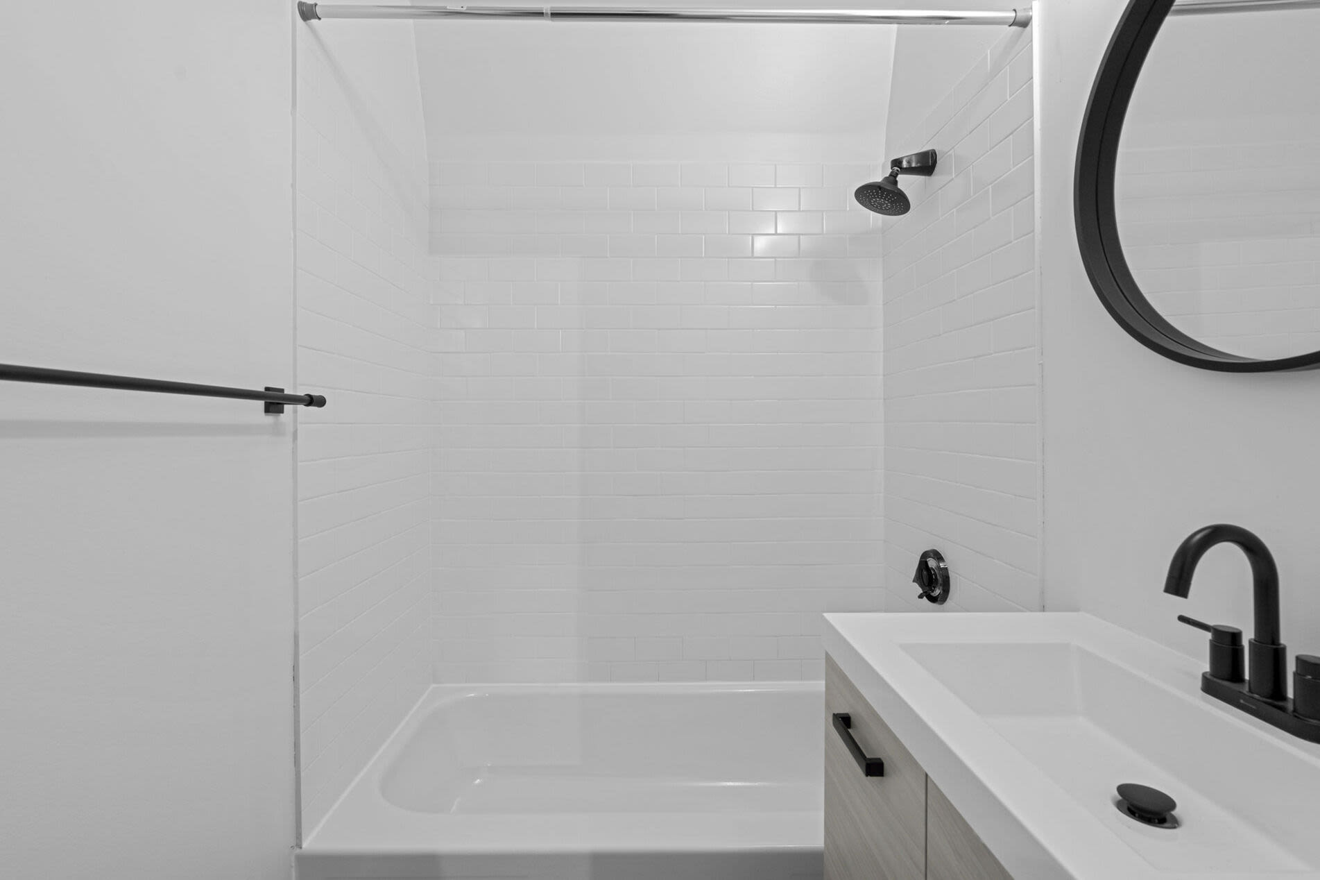 Bathroom with a toilet, sink, and standard tub at Mercantile Wharf in Boston, Massachusetts