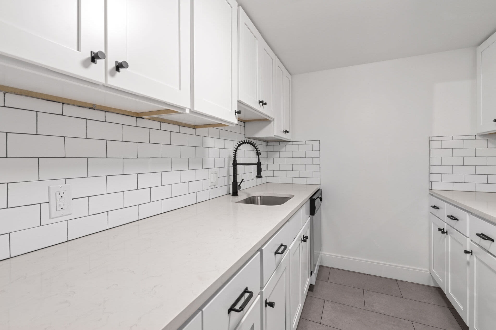 Spacious kitchen with full-equipped stainless-steel appliances at Mercantile Wharf in Boston, Massachusetts