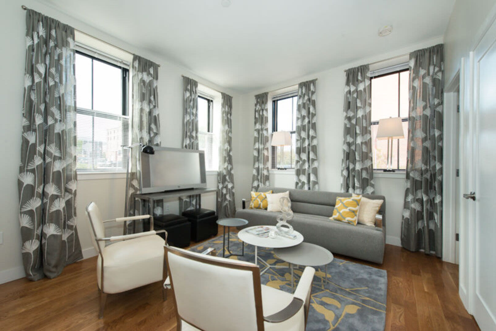 Living room with sitting space and tv at Station Lofts in Brockton, Massachusetts