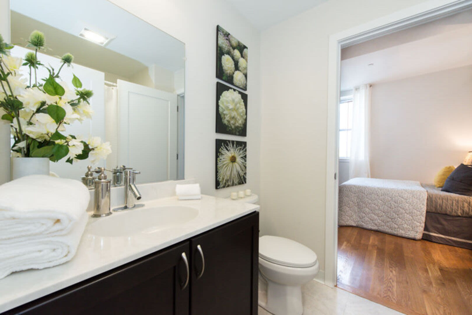 Bathroom with large mirror and storage space at Station Lofts in Brockton, Massachusetts