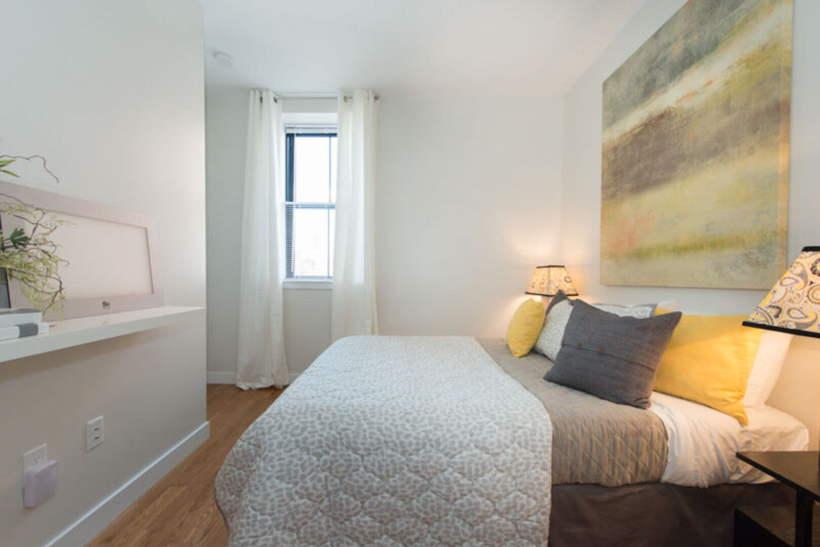 Bedroom with large comfortable bed and a window at Station Lofts in Brockton, Massachusetts