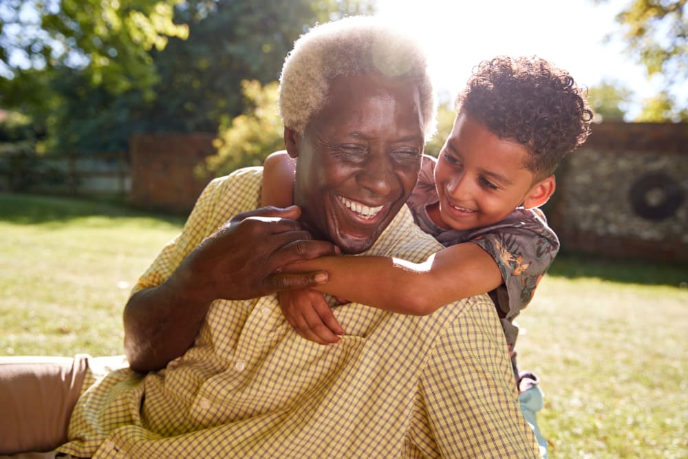Resident and grandchild play outdoors at Sunset Park Place in Dubuque, Iowa.