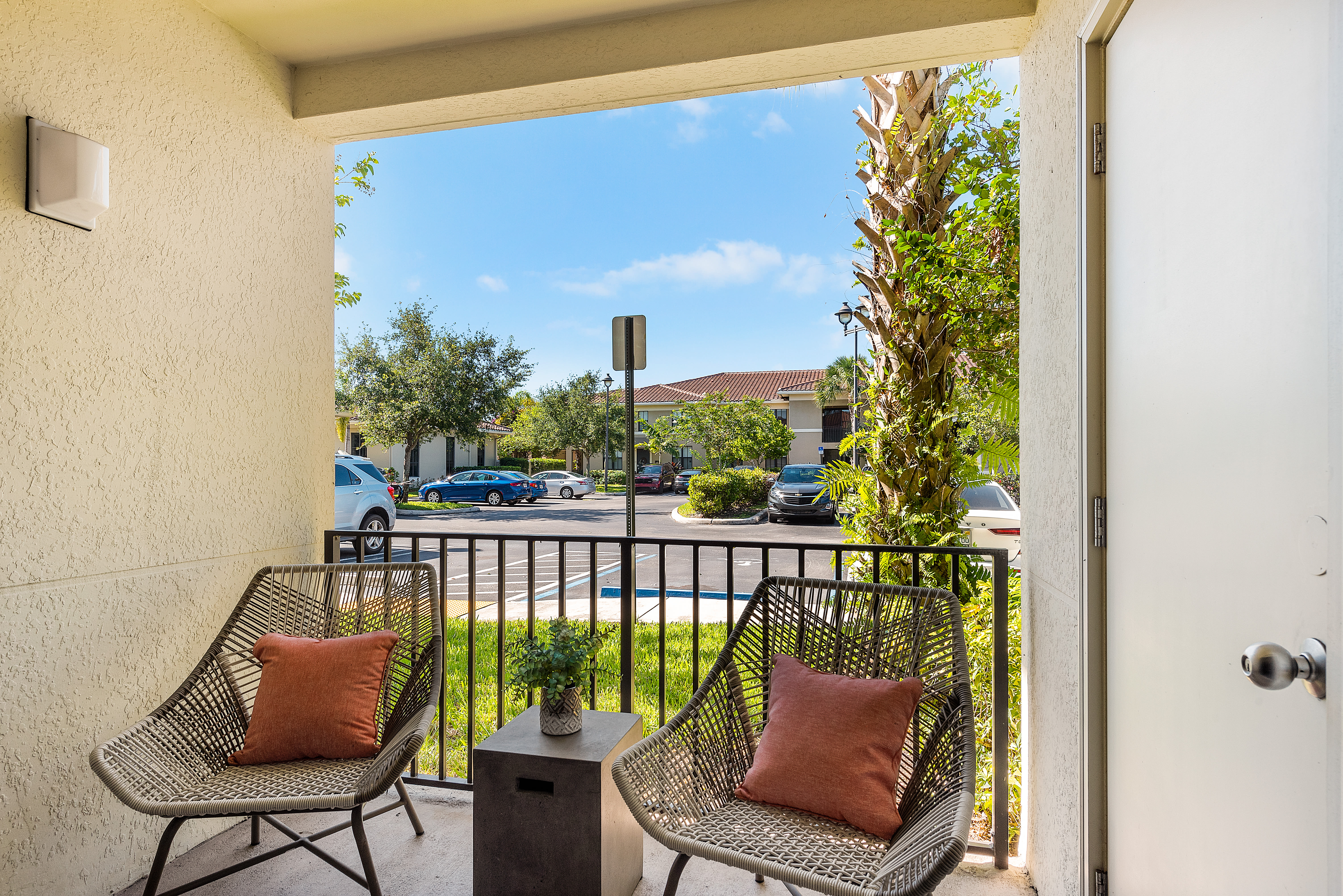 Private balcony with modern chairs and table at The Residences at Lakehouse in Miami Lakes, Florida
