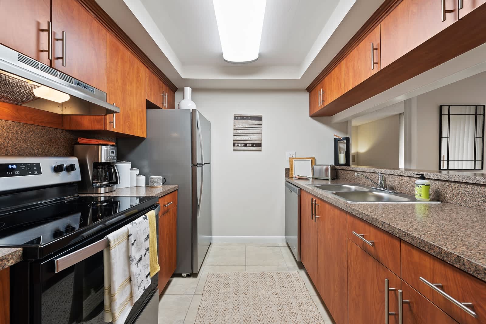 Fully equipped kitchen with stainless steel appliances at New Barn Apartments in Miami Lakes, Florida