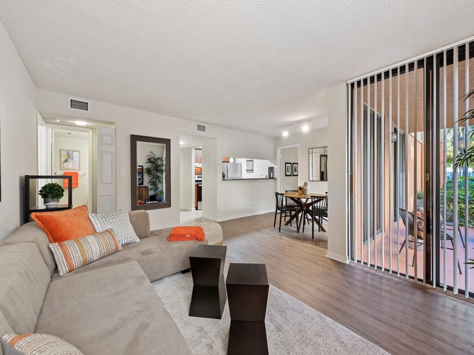 Spacious living room with lots of natural light at New Barn Apartments in Miami Lakes, Florida