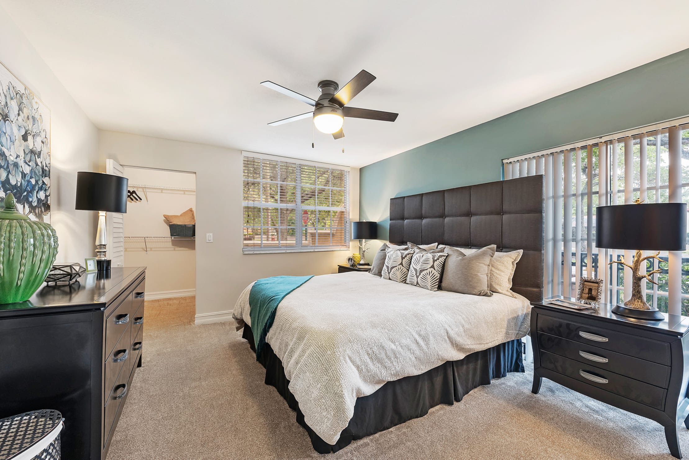 Model bedroom with ceiling fan and walk-in closet at Crescent House Apartments in Miami Lakes, Florida