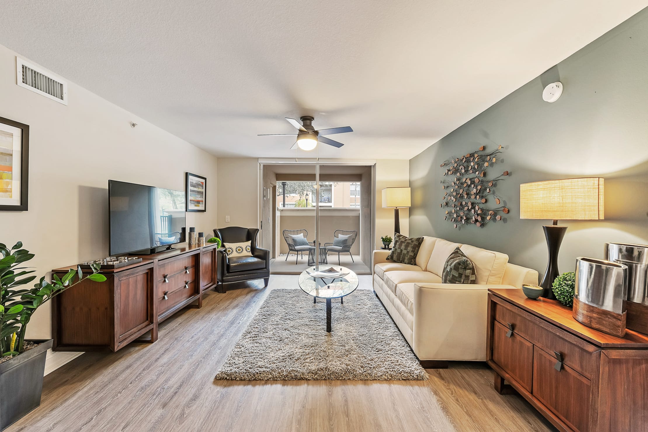 Open concept living room, dining room, and kitchen in a luxury apartment home at Crescent House Apartments in Miami Lakes, Florida