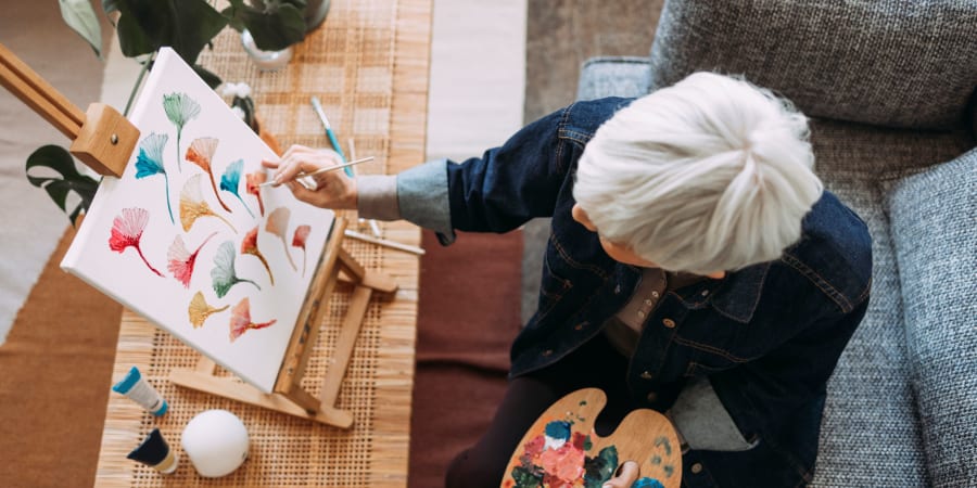 resident painting on canvas at All Seasons West Bloomfield in West Bloomfield, Michigan