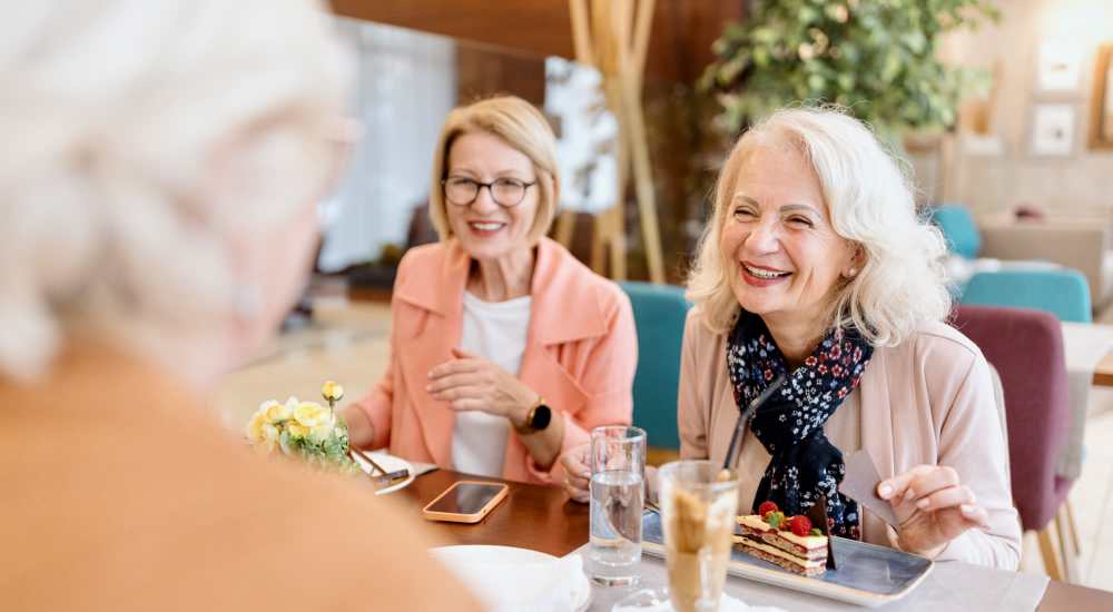 Friends enjoying food at a restaurant near Del Amo Gardens in Long Beach, California