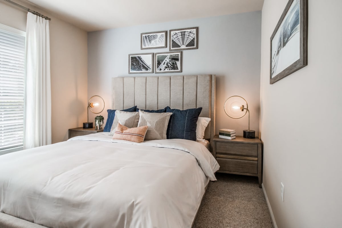 Bright and cheerful bedroom with carpet at Marquis at Carmel Commons in Charlotte, North Carolina