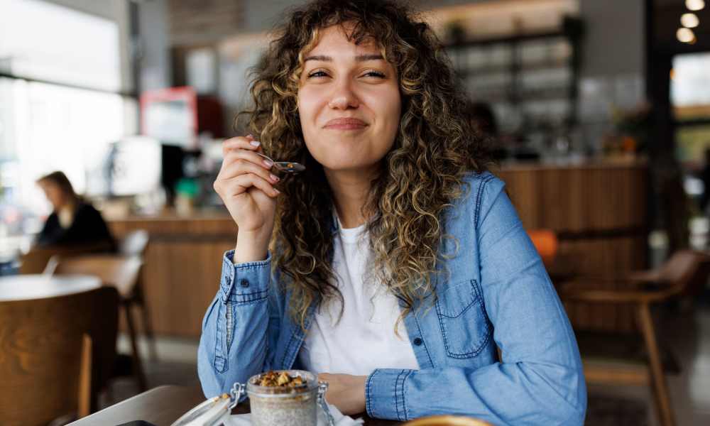 Resident enjoying coffee at cafe near Avonlea On The River in Duluth, Georgia
