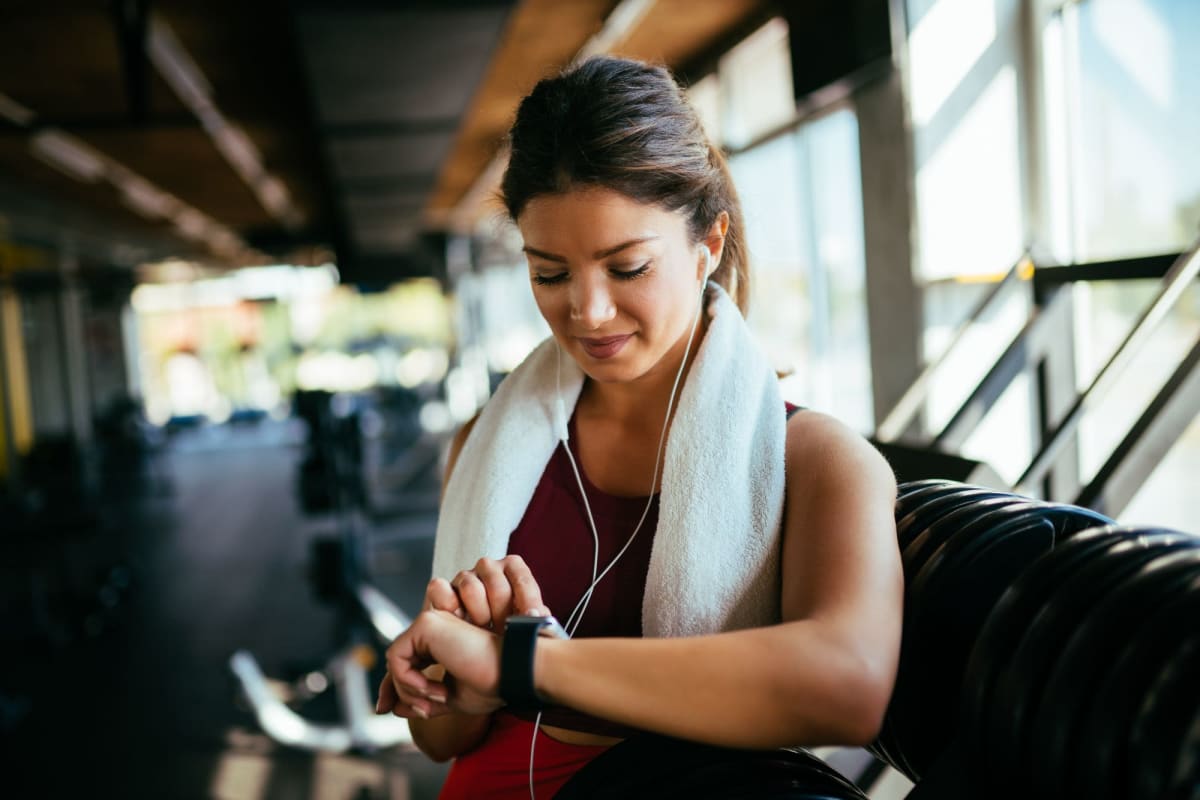 Resident setting her watch at the fitness center at Parallel 36 at Liberty in Athens, Alabama